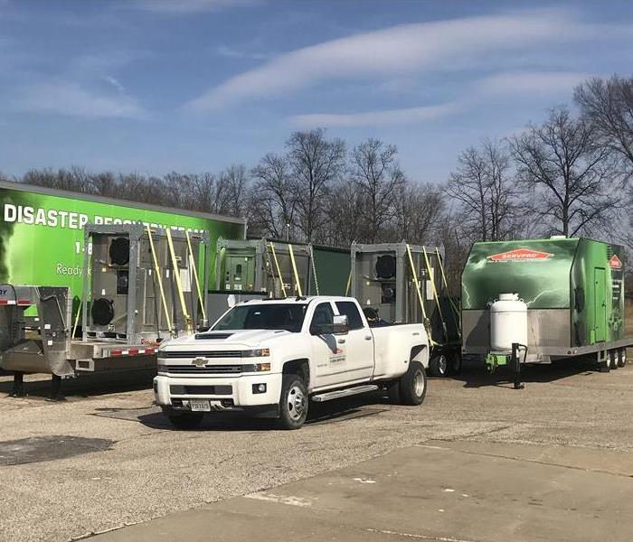 Several green disaster recovery trucks in barberton/norton