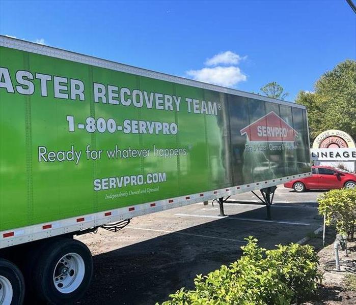 Servpro semi outside of a flooded building