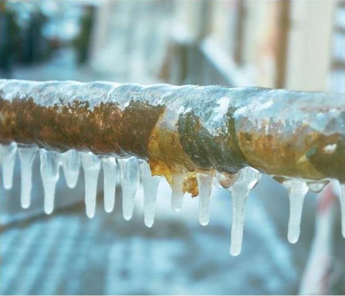 Frozen pipe with icicles hanging off of it