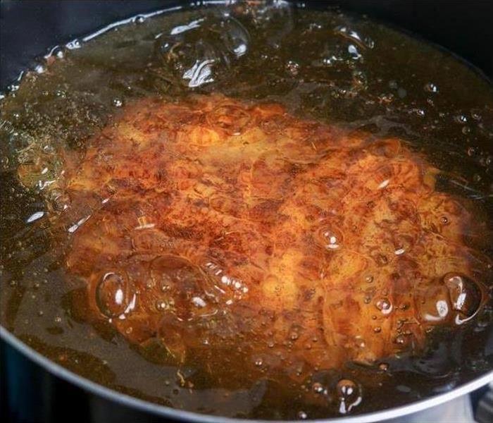 turkey sitting in oil fryer